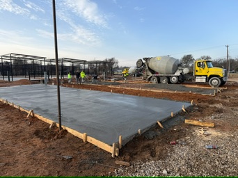 Ready-mix delivery and active RV-pad placement at Magnolia RV