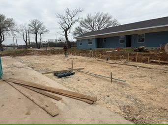 Defined corners and staged prep work in the Melody Grove accessible-parking area