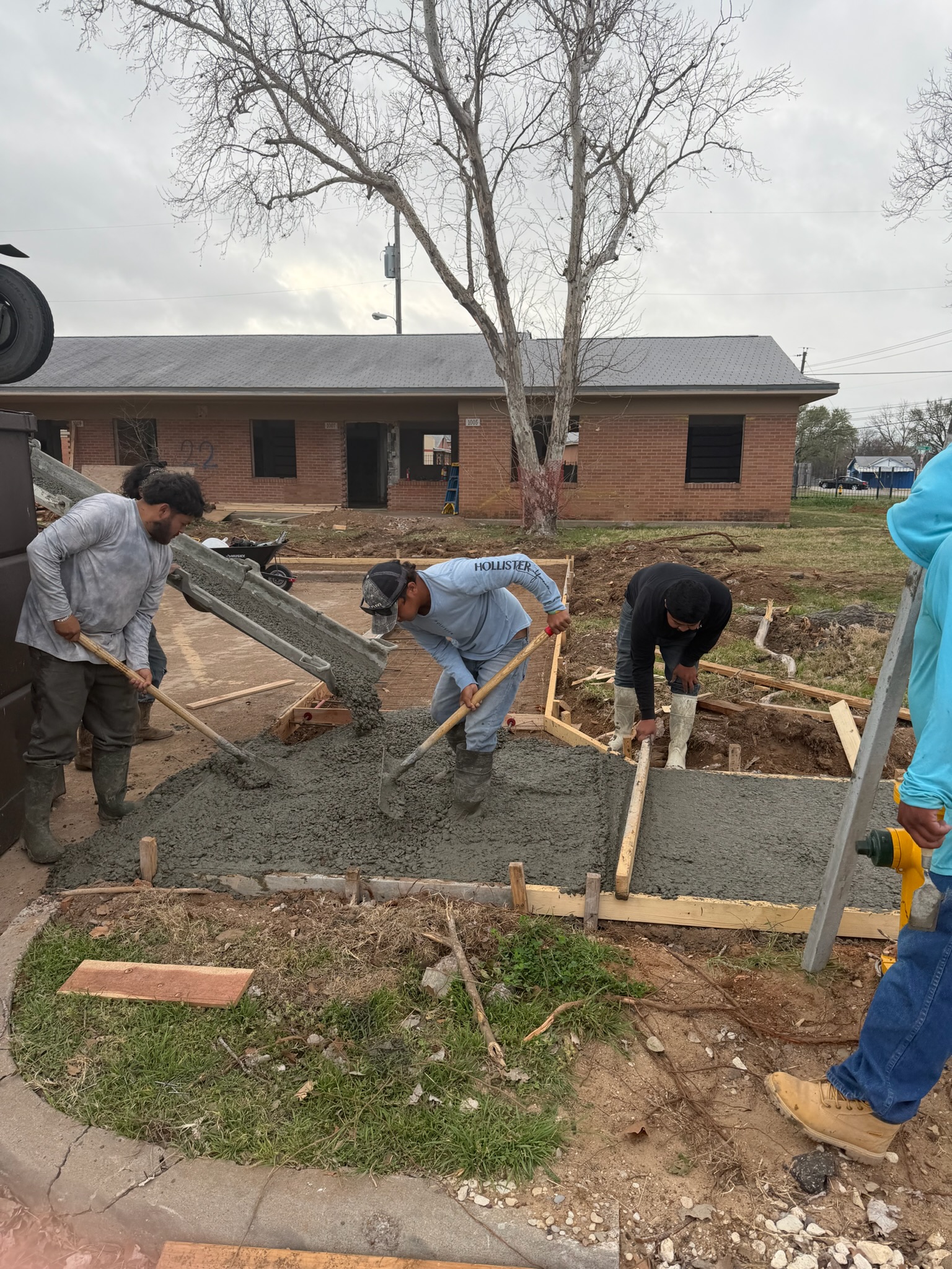 Concrete placed from a truck chute into City of Waco sidewalk forms