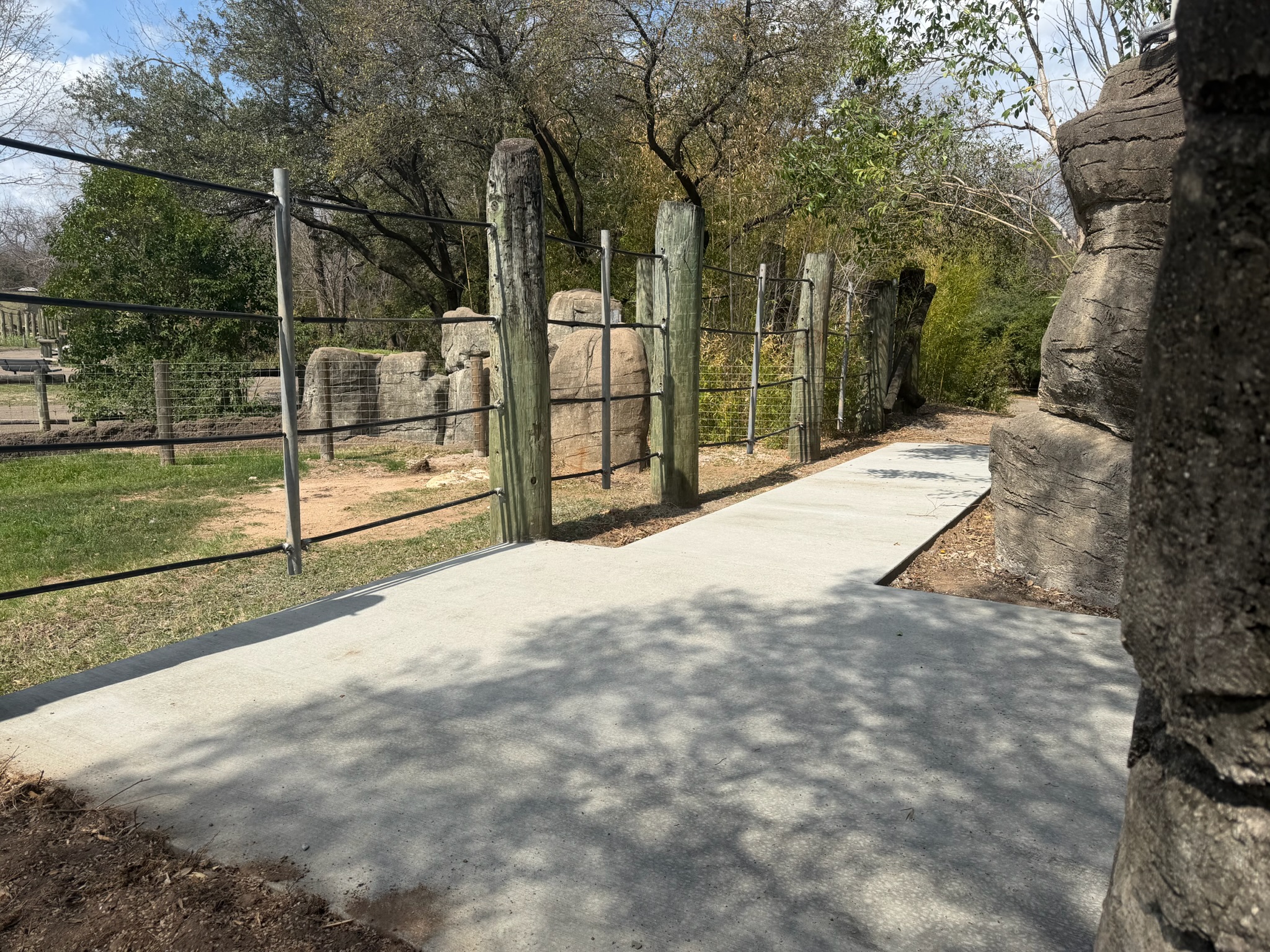 Finished walkway edges beside posts and landscaping at Cameron Park Zoo